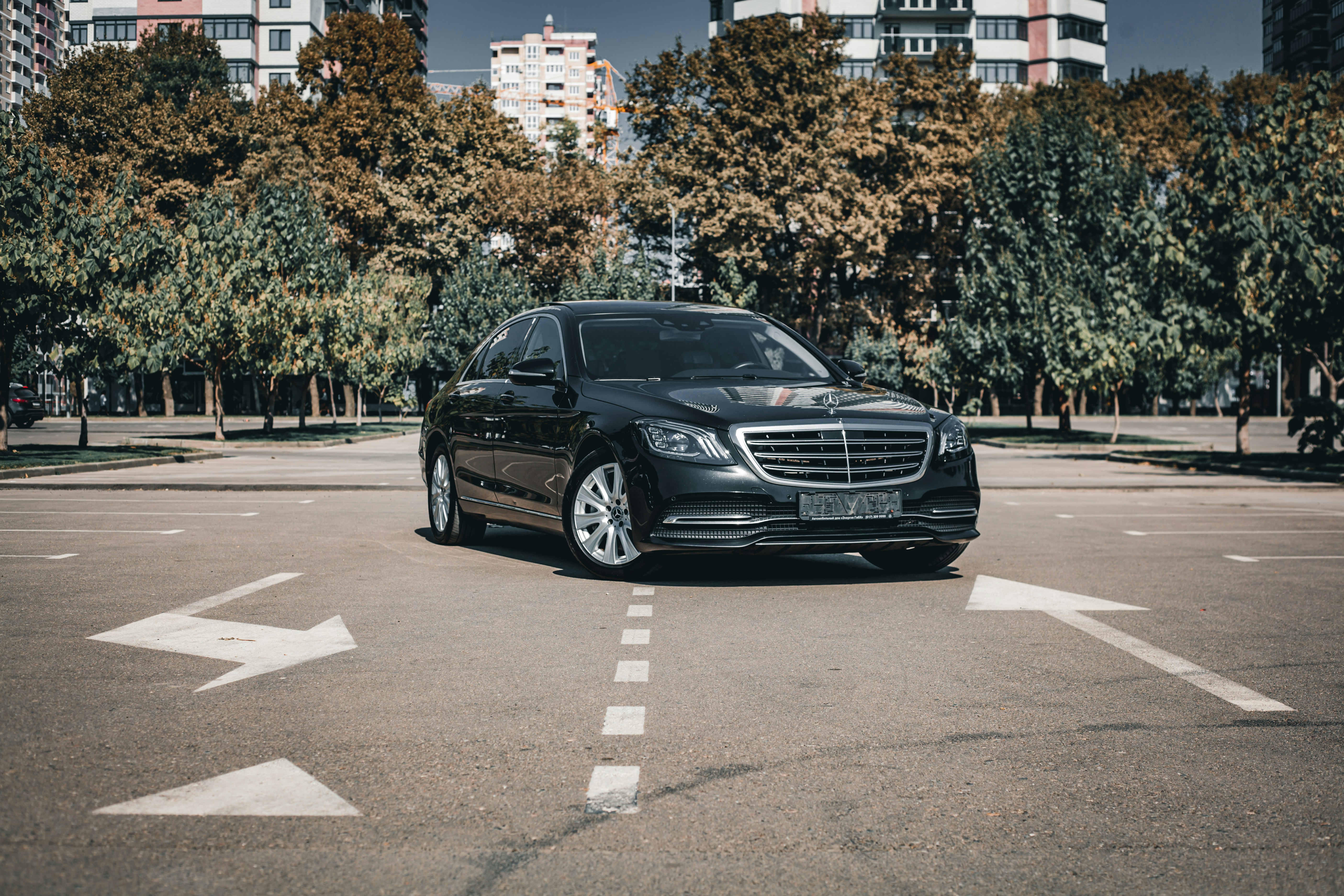 Black executive sedan waiting on a city street